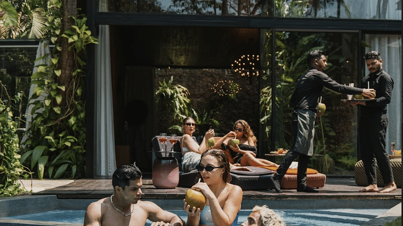 A bunch of people drinking cocunut water in a swimming pool